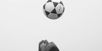 Man on Shore Doing Soccer Trick